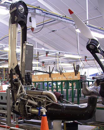 
Powerplant from a Schleicher ASH 26e self-launching motor glider, removed from the glider and mounted on a test stand for maintenance at the Alexander Schleicher GmbH & Co in Poppenhausen, Germany. Counter-clockwise from top left: propeller hub, mast with belt guide, radiator, Wankel engine, muffler shroud.