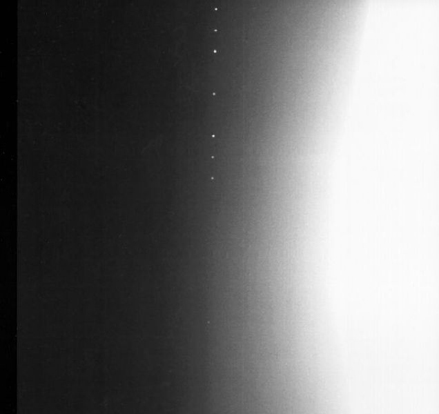 
Image taken by Galileo of Earth during GOPEX test clearly showing bright laser pulses coming from a transmitting telescope on the night side. Galileo's imager was panned downward during the exposure to separate the pulses, thus blurring earth's image on the right.