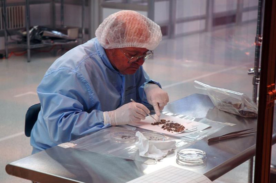
Genesis staff have started sorting through the debris from the sample canister.