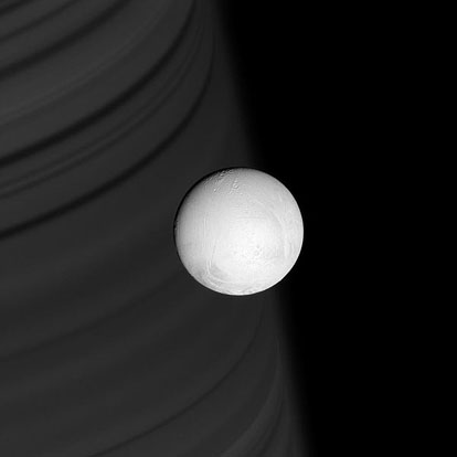 
Enceladus backdropped Saturn's ring shadows.