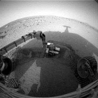 
NASA's Mars Exploration Rover Spirit casts a shadow over the trench that the rover is examining with tools on its robotic arm. Spirit took this image with its front hazard-avoidance camera on February 21, 2004, during the rover's 48th martian day, or sol 48.